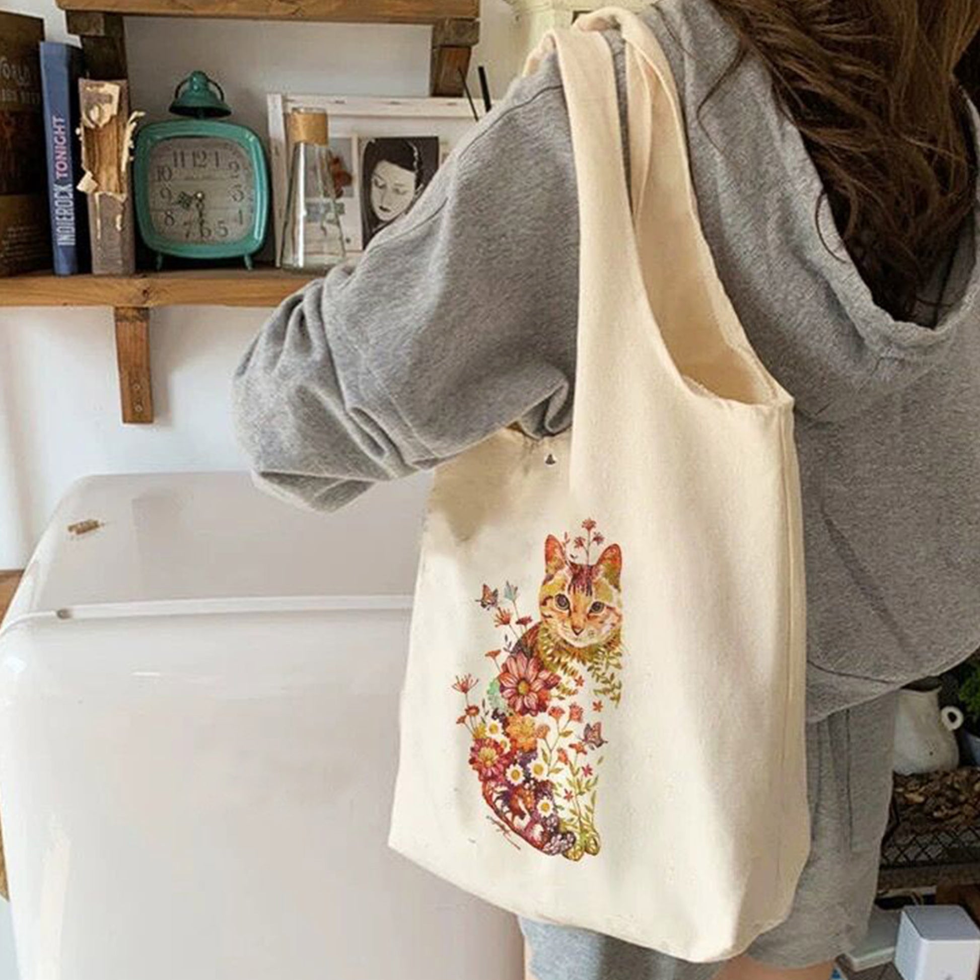 A girl is wearing a tote bag on her shoulder which is personalized with as image of a girl on it.