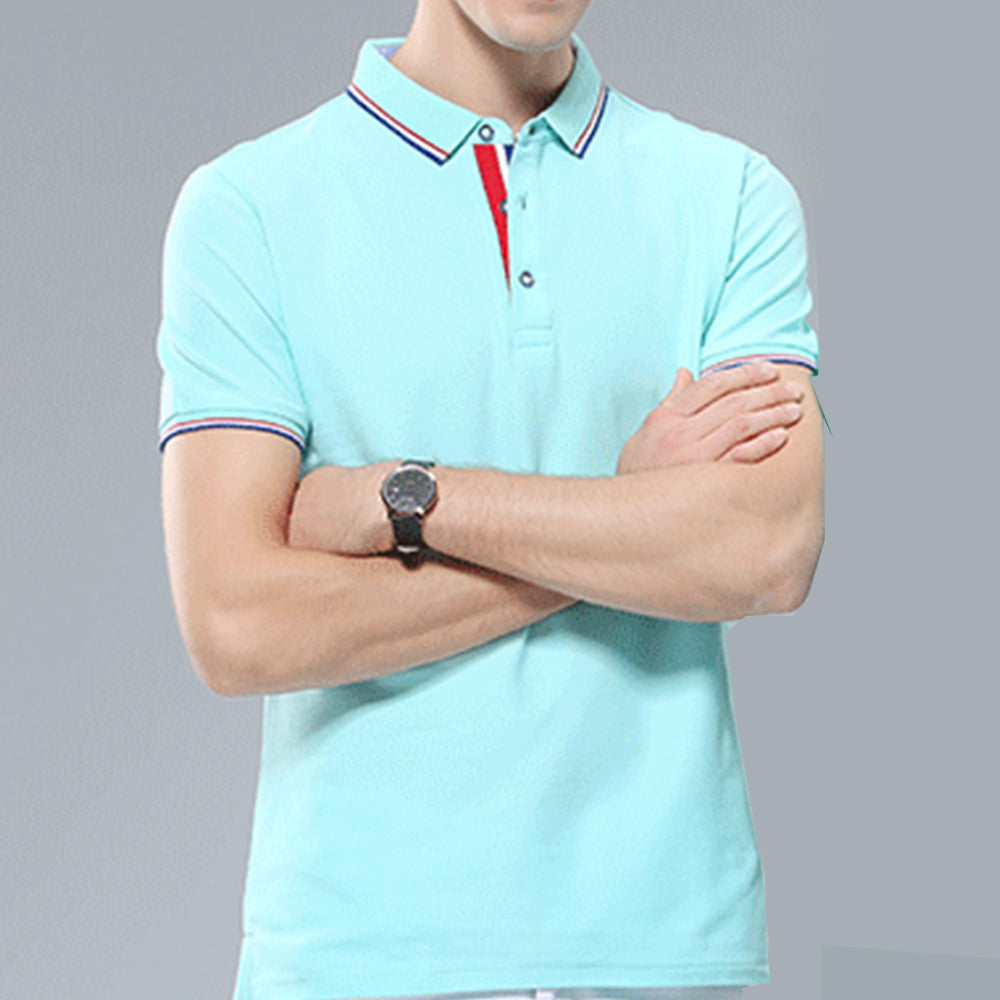 A picture of a male wearing a light blue custom photo golf shirt with arms folded.