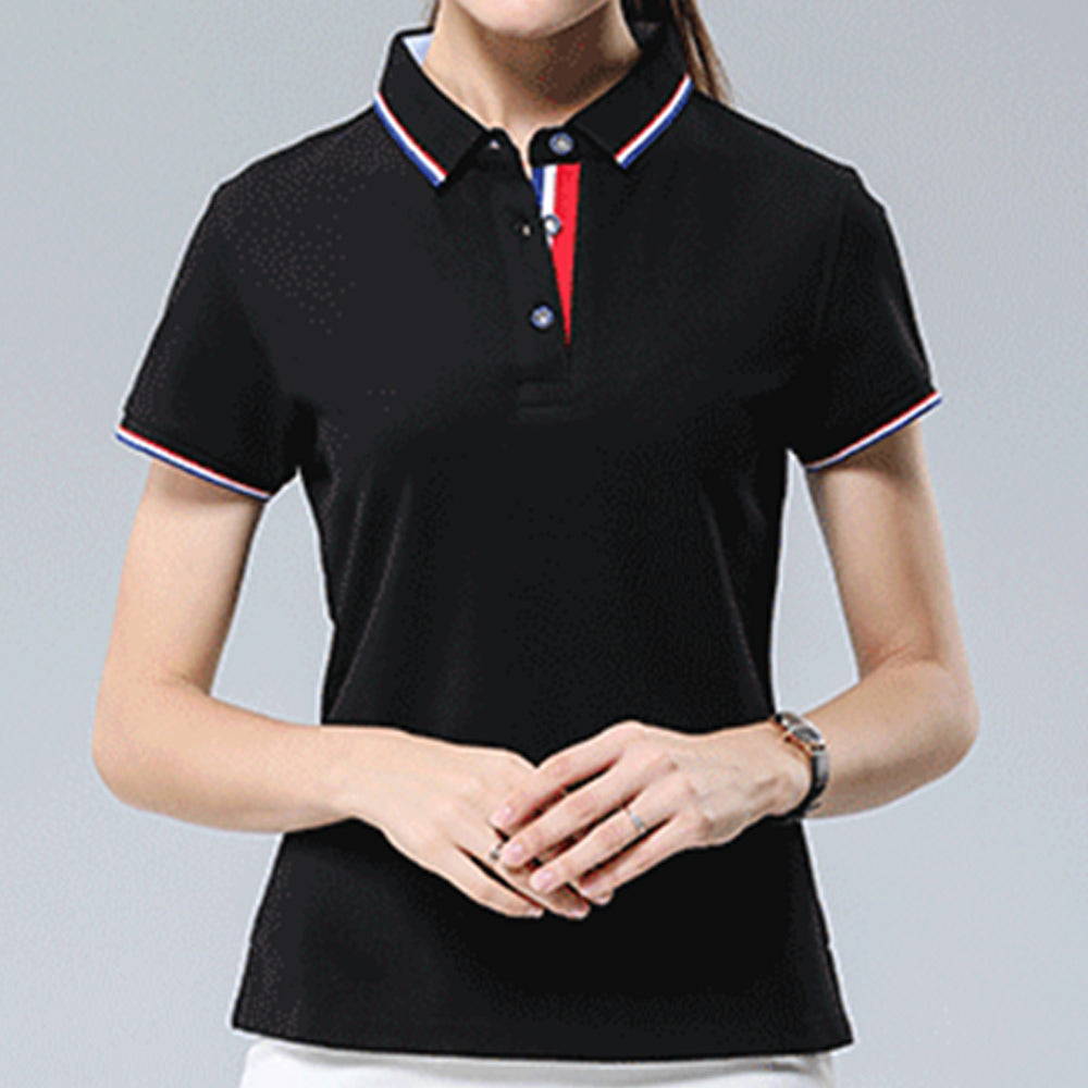 A picture of a woman standing with hands clasped, displaying a black personalized polo shirt on her.